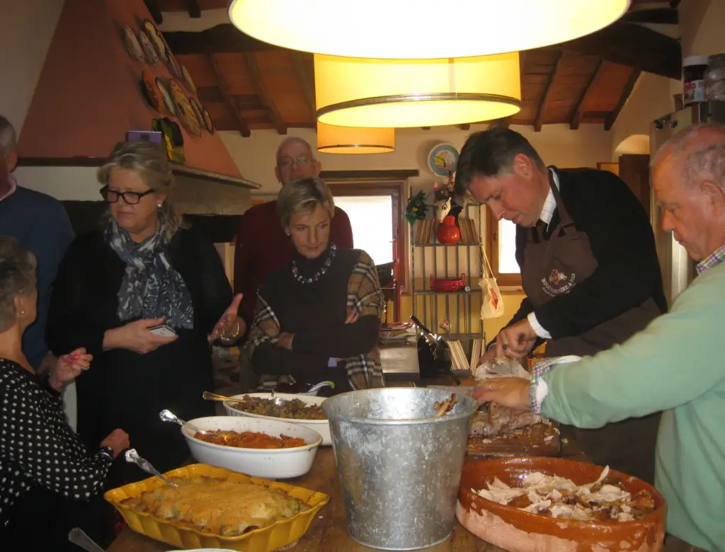 Everyone enjoys watching the turkey being cut (bucket for bones and etc) and conversations continue...