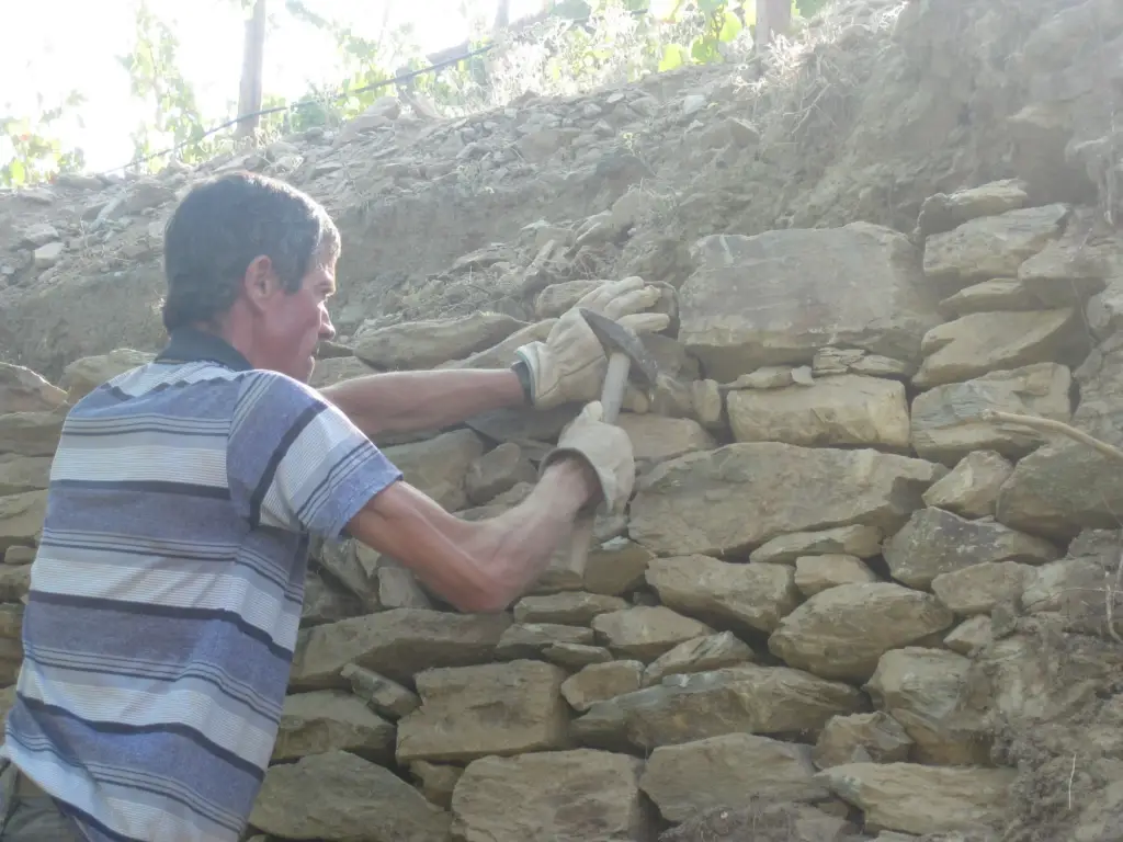 Filling in with smaller rocks for strengthening walls.
